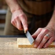 Lead carpenter working with a chisel